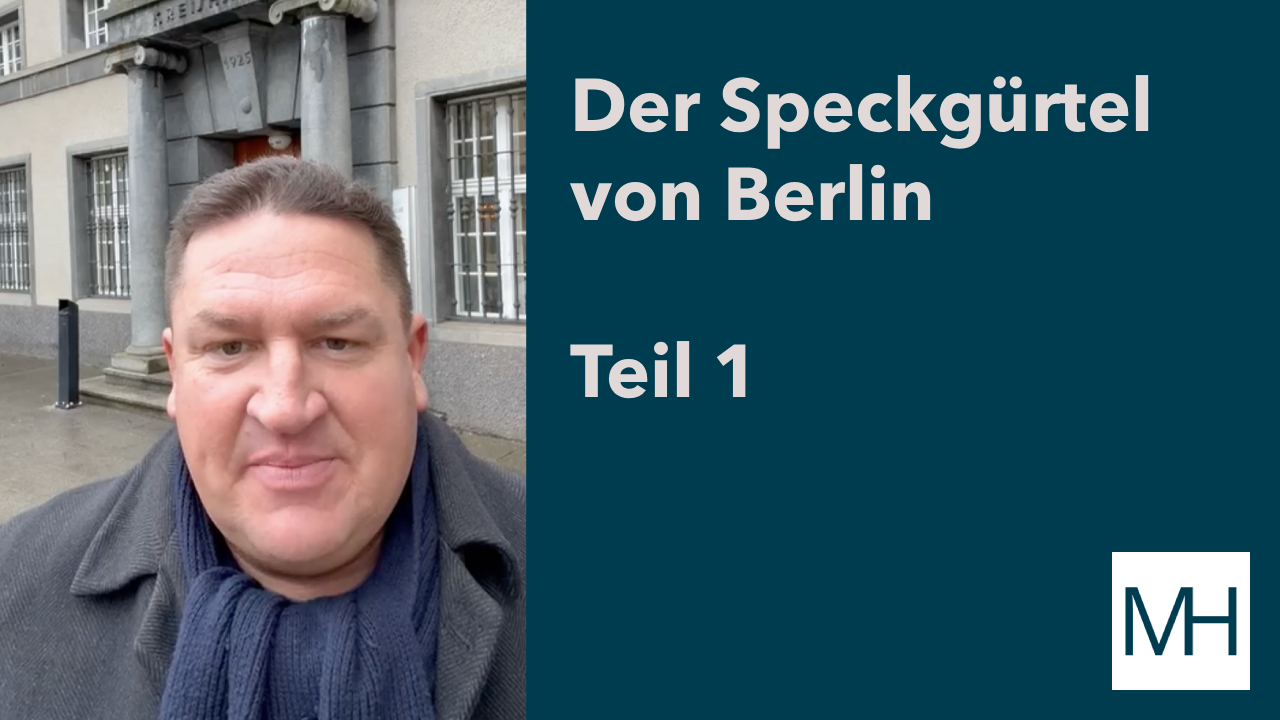 Marcus Held spricht in einem Videobeitrag vor einem Gebäude im Havelland über den Speckgürtel von Berlin und die Entwicklung bezahlbaren Wohnraums im Berliner Umland (Teil 1).